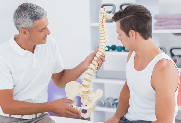 two guys looking at a spine