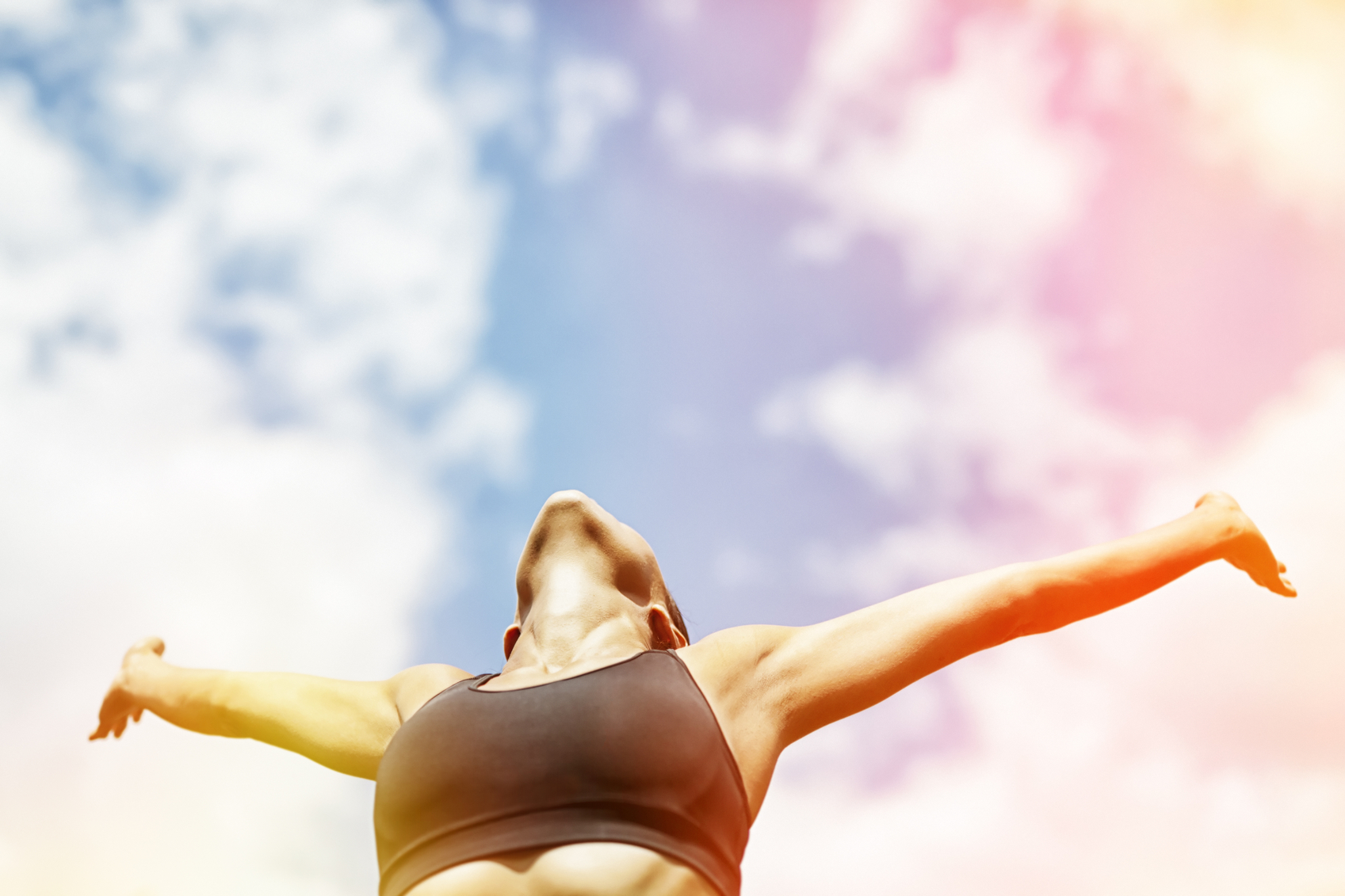 woman looking victoriously into the sky