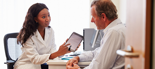 Doctor showing patient information on tablet