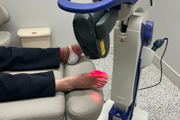 Robotic M6 MLS Therapy Laser Treating a Patient's Foot Post-operatively
