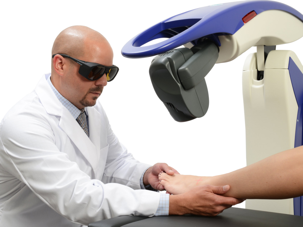 A Podiatrist is treating a patient's food with the Robotic M6 MLS Therapy Laser