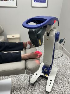 The Robotic M6 MLS Therapy Laser treating a patient's foot after surgery