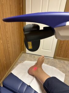 The M6 MLS Therapy Laser treating a patient's ankle in Dr. Waldman's clinic