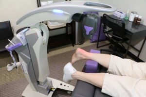 A patient receives laser therapy treatment on the Achilles tendon with the M7 MLS Therapy Laser at Dr. Foster's practice.