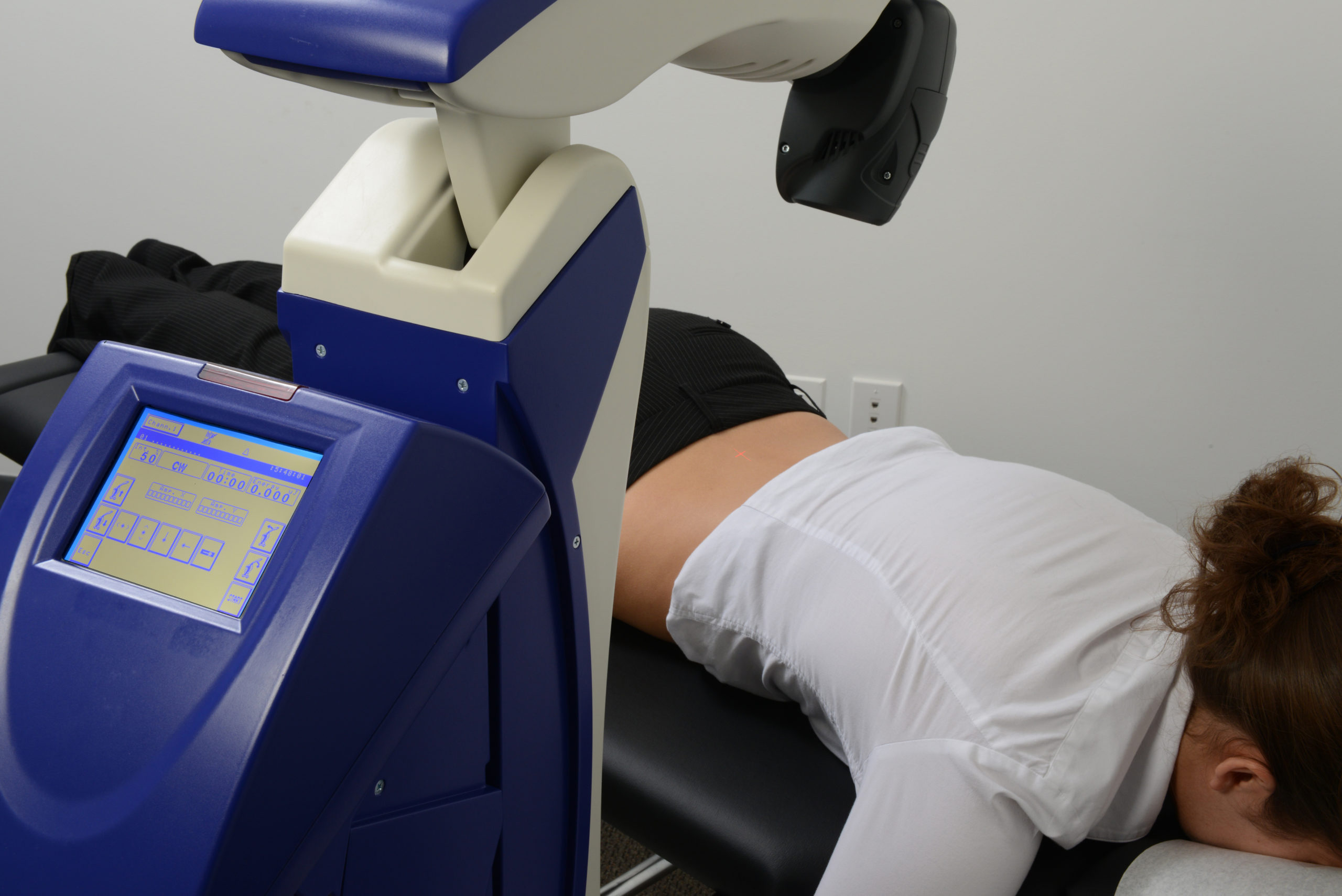 The Robotoc M6 MLS Therapy Laser being used to treat a woman's lower back